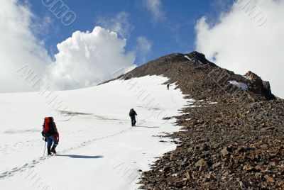 Three men trekking  on a mountain