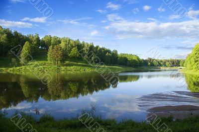 Blue reflection in river  at summer forest, Russia