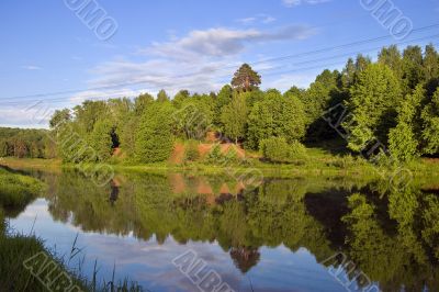 Blue reflection in lake at summer forest