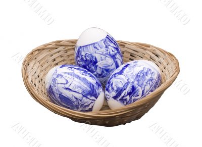 Easter eggs in a basket on the isolated white background