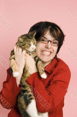young woman holding domestic cat