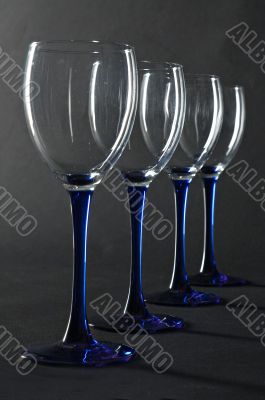 Four empty blue wine glasses
