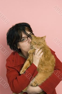 beautiful woman holding a domestic red cat