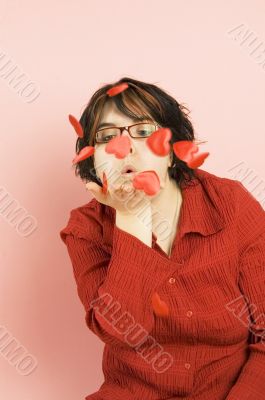 young beautiful woman blowing hearts away