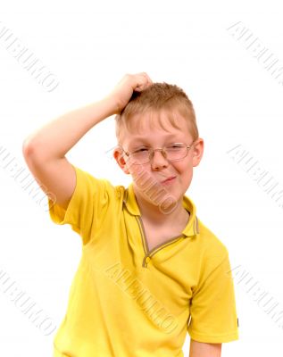 Boy scratches his head in puzzlement or confusion