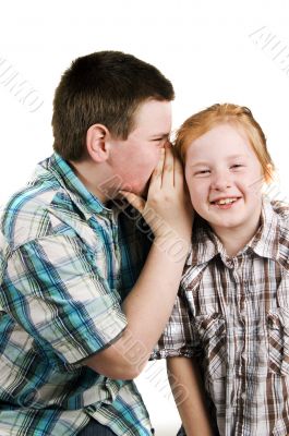 boy is whispering in girls ear boy is whispering in girls ear