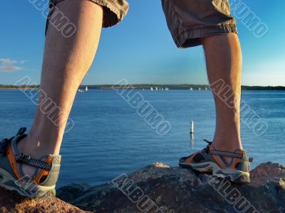 Man standing on Rocks near Sea