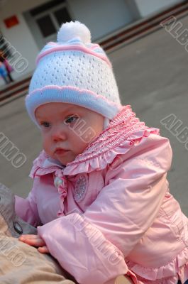 Pretty little girl on mother`s hands.