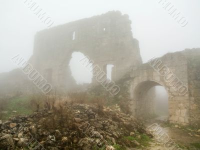 age-old stronghold gate arched mist morning
