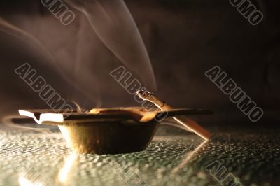 Ash-tray and cigarette