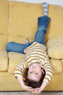 Boy lying down on the sofa at home Boy lying down on the sofa at home