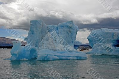 Iceberg in lake Argentino and ship
