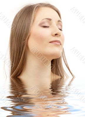 beautiful woman with closed eyes in water