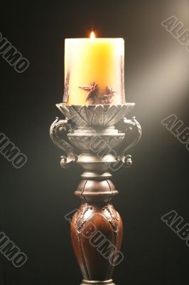 Antique wooden candlestick with ray of light Antique wooden candlestick with ray of light