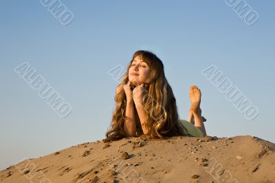 blond girl lying on the beach