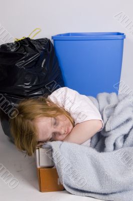 homeless kid sleeping in a box