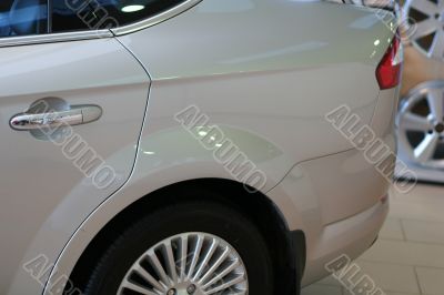 detail of new car in dealership showroom