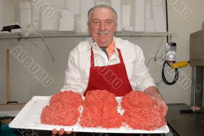 Butcher showing ground beef Butcher showing ground beef