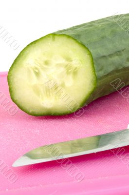 Part of a cucumber on a cutting board Part of a cucumber on a cutting board