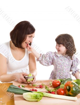 mother and daughter cooking at the kitchen