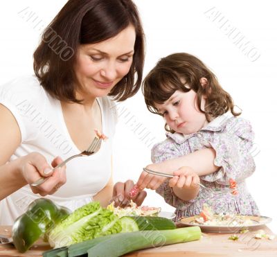 mother and daughter cooking at the kitchen