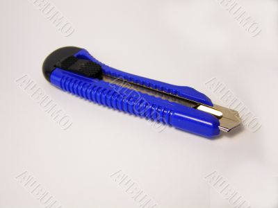 Dark blue plastic knife on a white background