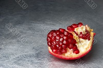 broken pomegranate on scratched metall