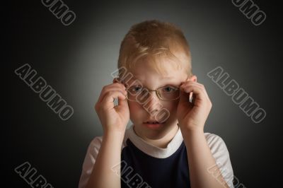 Boy try on a glasses
