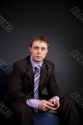 Businessman relaxing with cognac