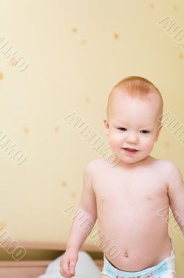 Enjoying baby stand on bed