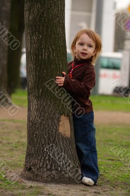 Small beauty girl playing hide-and-seek