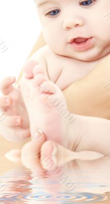 bathing baby in mother hands