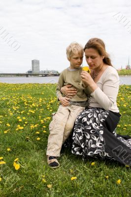 Mother and son in Dandelion meadow Mother and son in Dandelion meadow