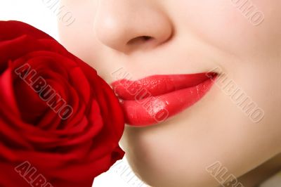 Close-up of beautiful girl with red rose