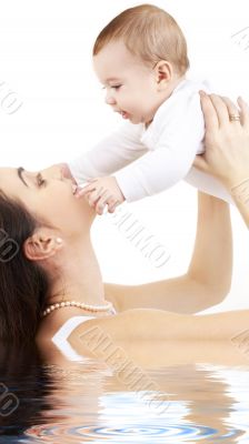happy mother with baby boy in water 2