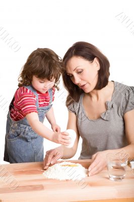 mother and daughter in the kitchen making a dough