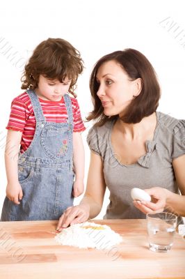 mother and daughter in the kitchen making a dough