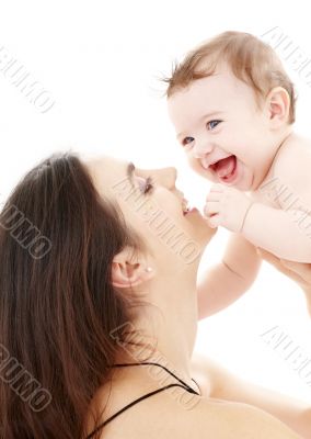 laughing blue-eyed baby playing with mom