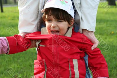 little girl is crying outdoors in spring park