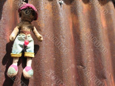 doll hung on a piece of metal