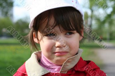 Offended and crying little girl in the park