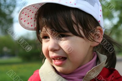 Offended and crying little girl in the park