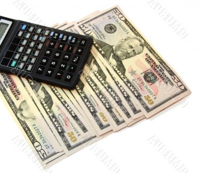 The calculator atop of dollar banknotes