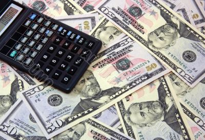 Calculator atop of dollars for backrounds Calculator atop of dollars for backrounds