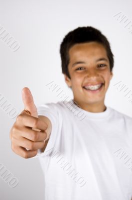 teenage boy with thumb up (focus on thumb)