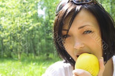 young happy woman eating apple