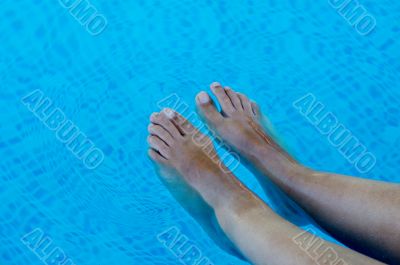 feet refreshing in swimming pool