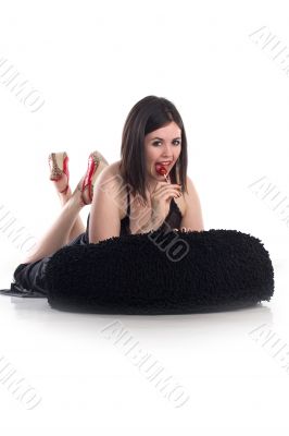 cute girl in nightie eating red lollipop