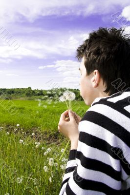 Teenager blowing dandelion Teenager blowing dandelion