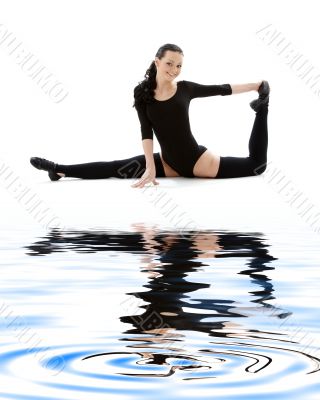 fitness instructor in black leotard on white sand #2